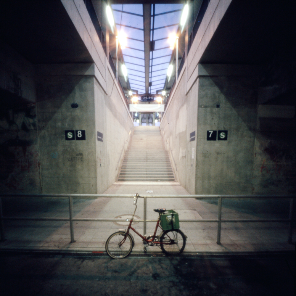 a pinhole camera picture showing the inside of a train stadtion and a bike