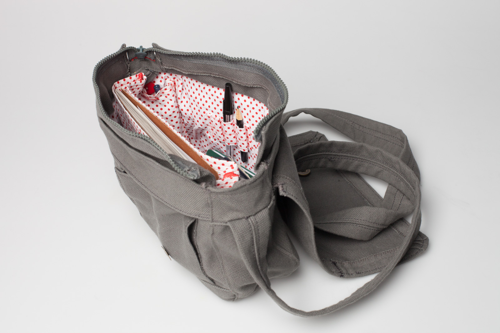 a simple fabric handbag – open, you can see the white with red dots inlay and a few pens and books on the inside