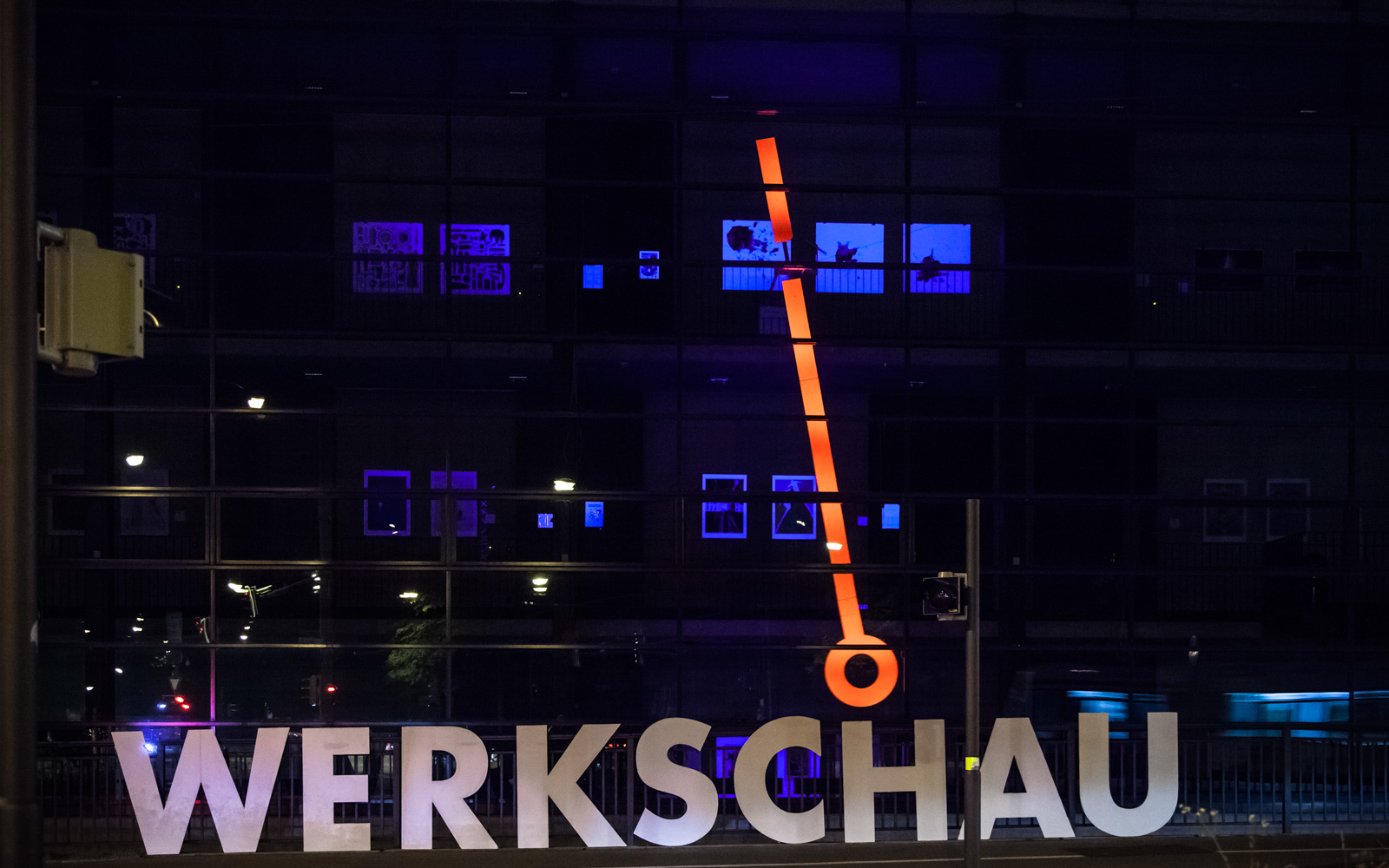 a short exposure shot at night where only the "werkschau" word and the pendulum can be seen