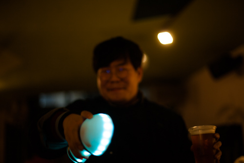 happy asian guy holding motion karoke (out of focus)