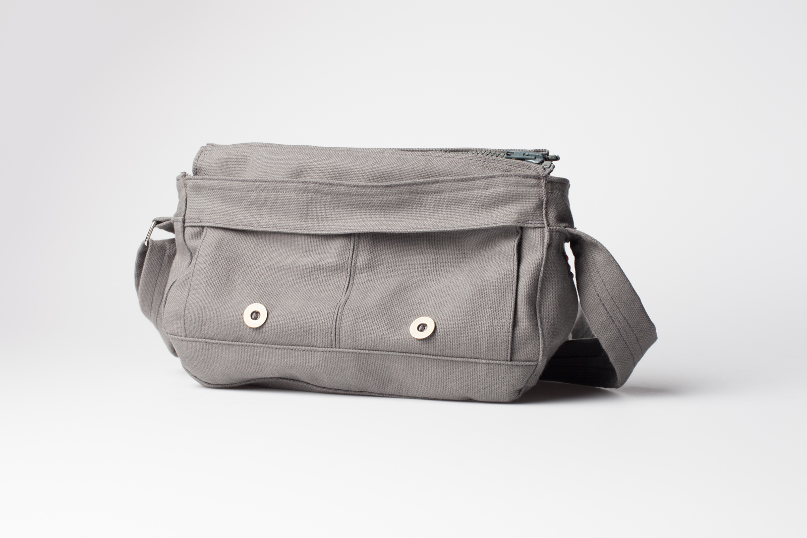 the closed grey fabric handbag with the two magnet buttons