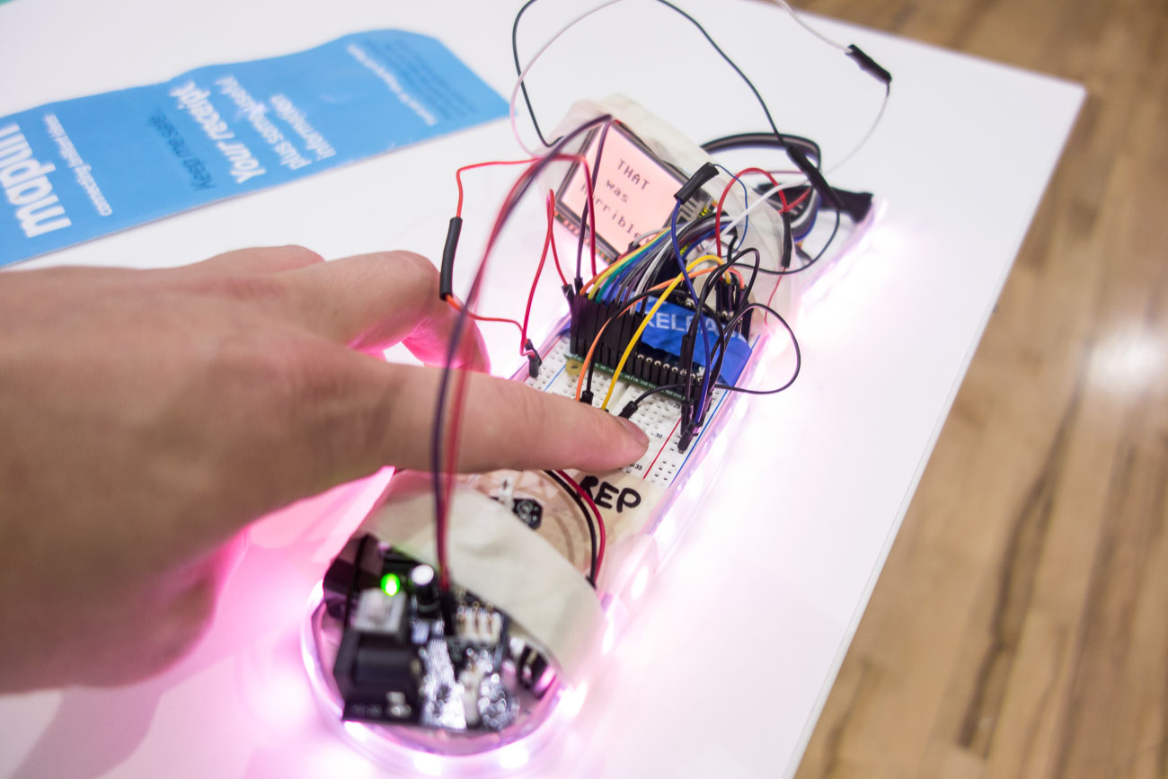 a hand testing the prototype that lights up